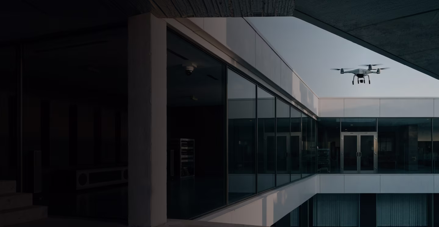 Commercial building with integrated security systems and a drone in flight